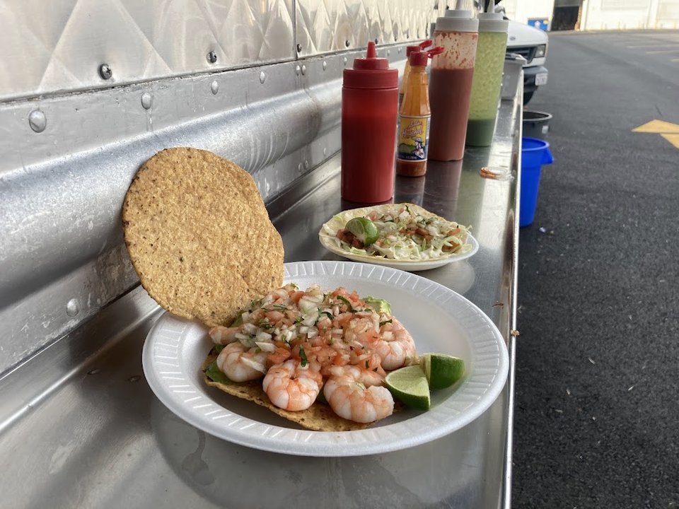 Shrimp tacos plated for dine-in service.